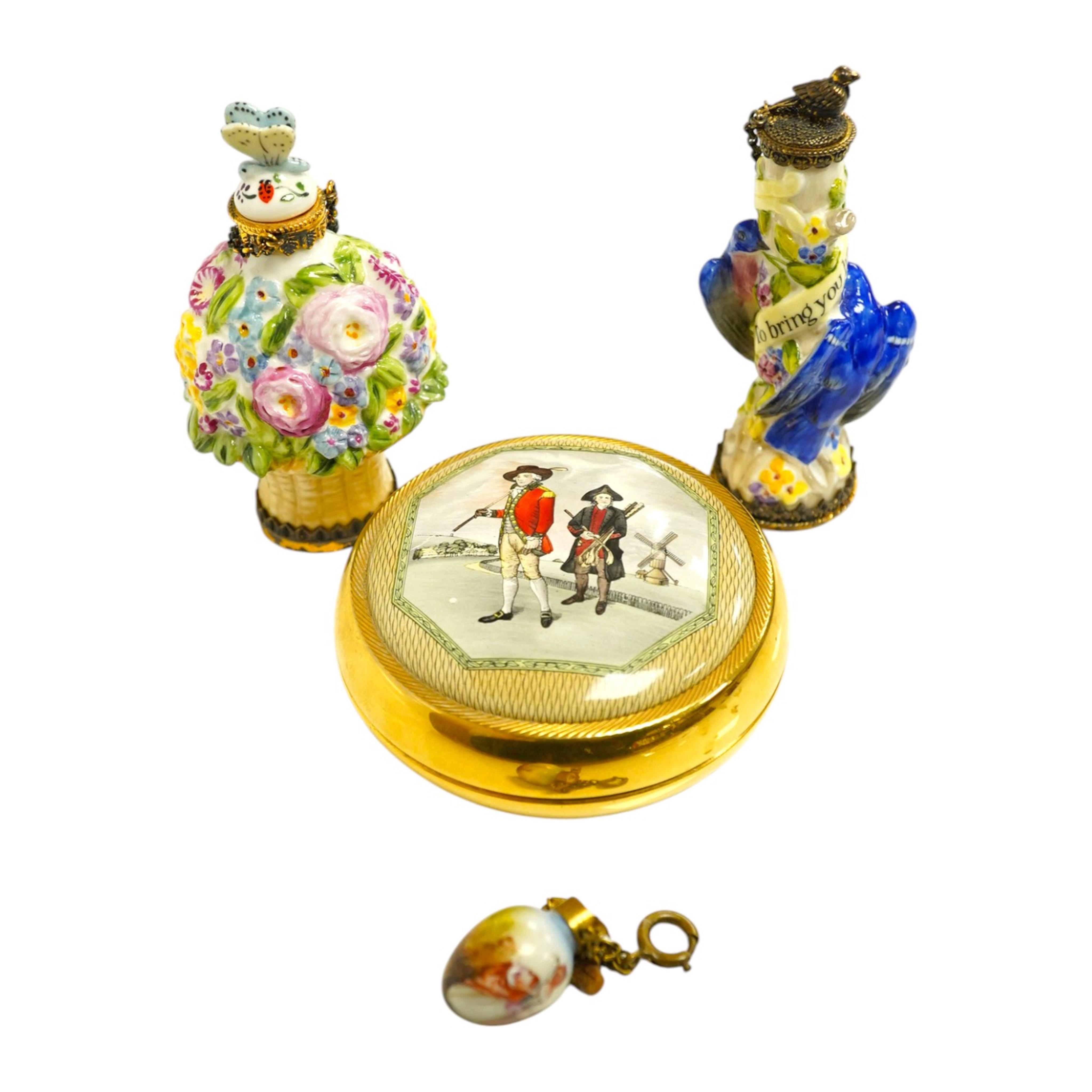 A miniature porcelain egg shaped scent bottle, on chain, two Halcyon Days scent bottles and a circular enamelled paperweight, (4). Condition - fair